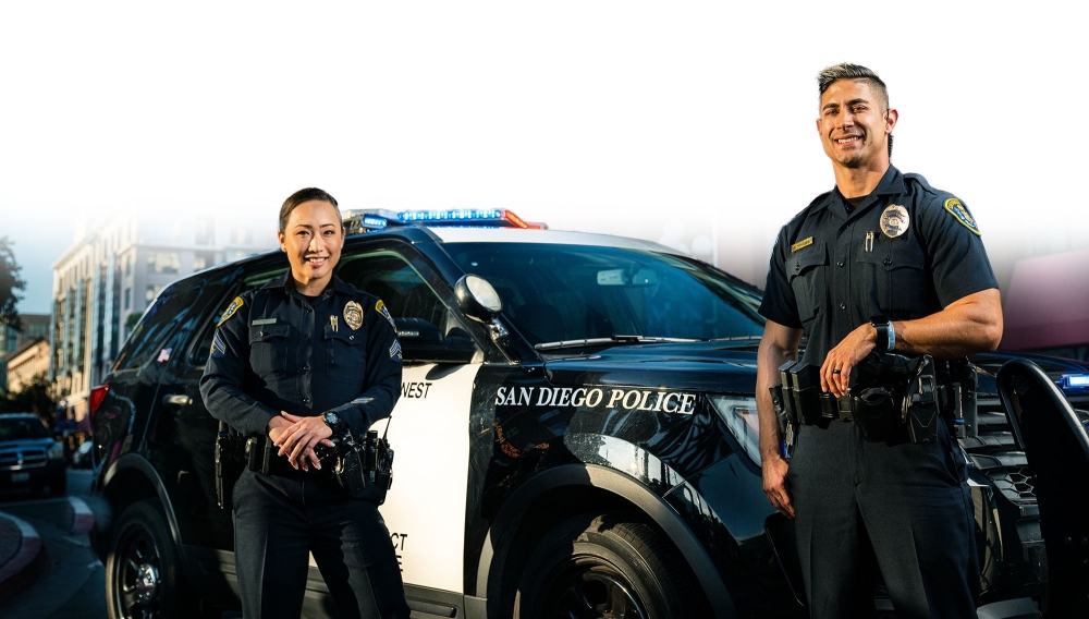 two cops standing next to a cop car