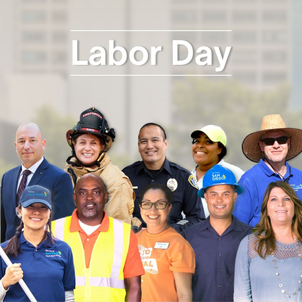 two rows of employees from various positions smiling in front of the city administration building