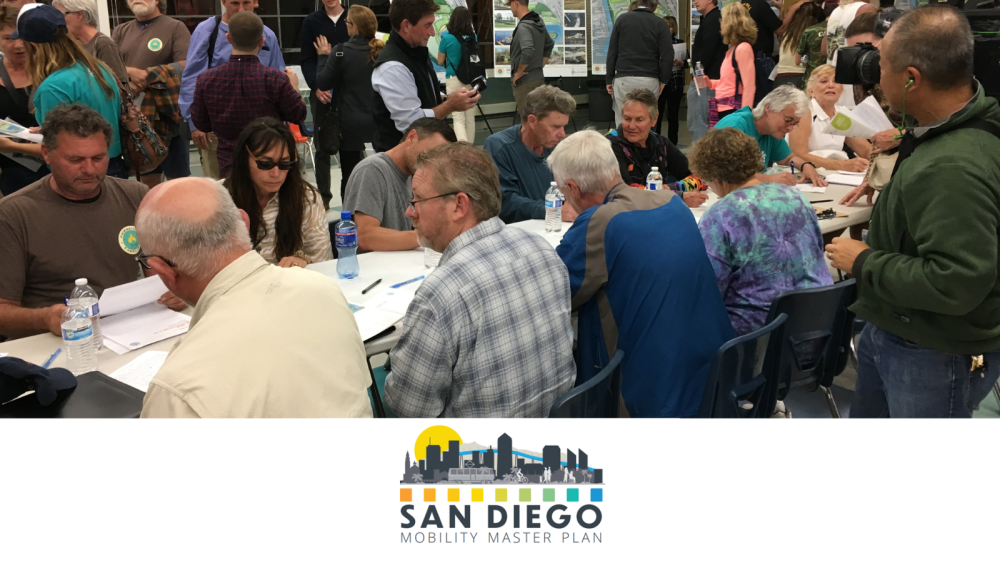 community members sitting at a table talking at a forum