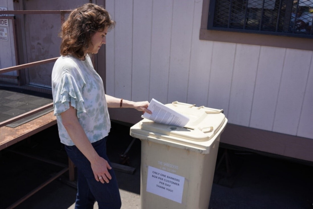 person recycling old tax documents