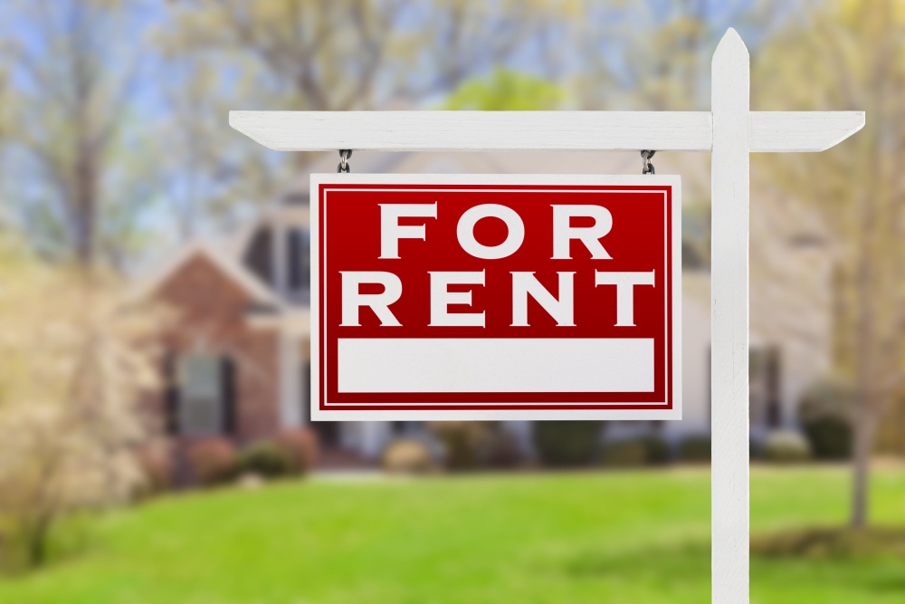 for rent sign posted in front of a house