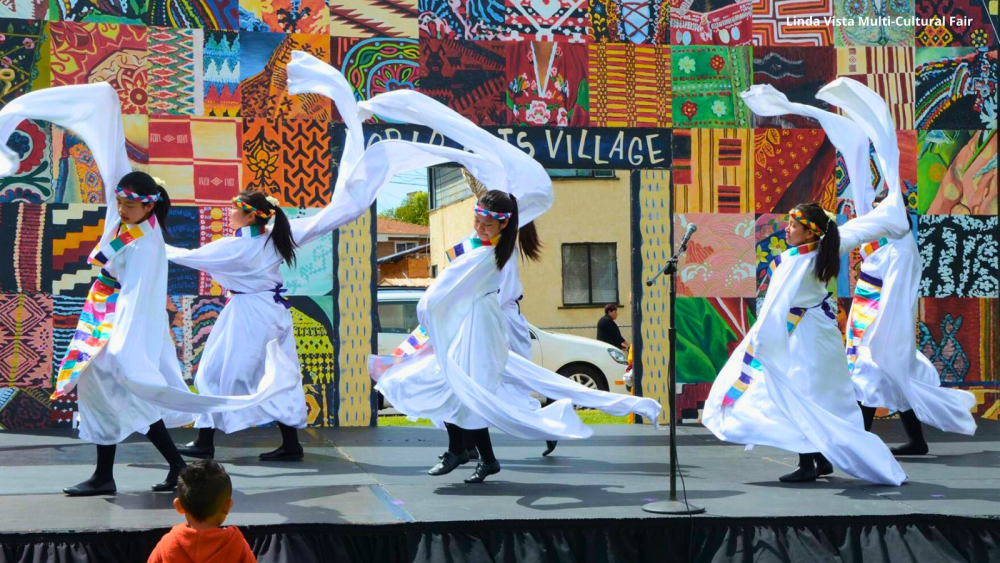 performers wearing white on stage 