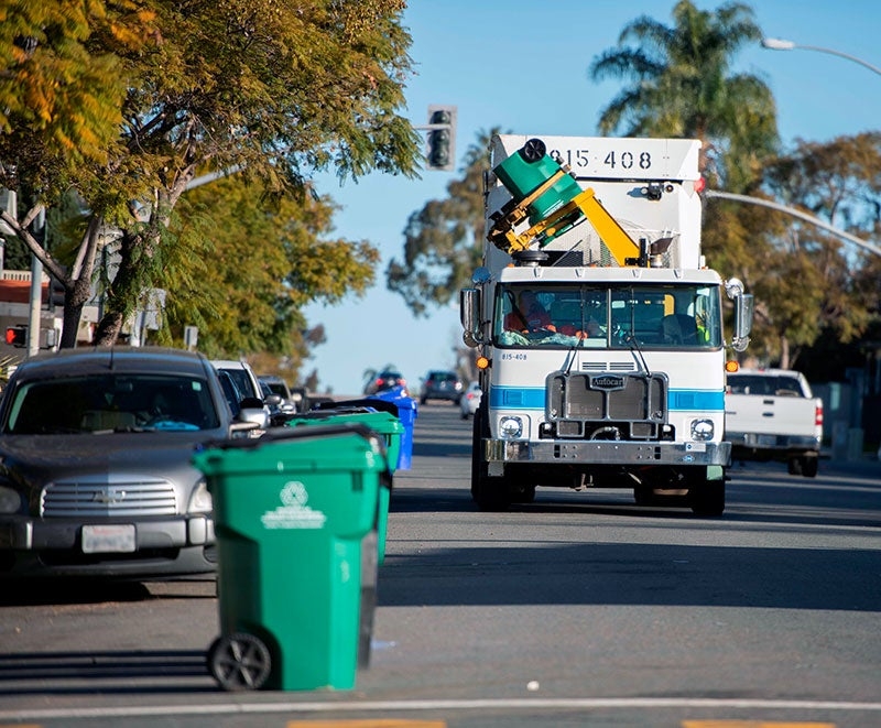 City of San Diego Waste Collection Truck on city street.