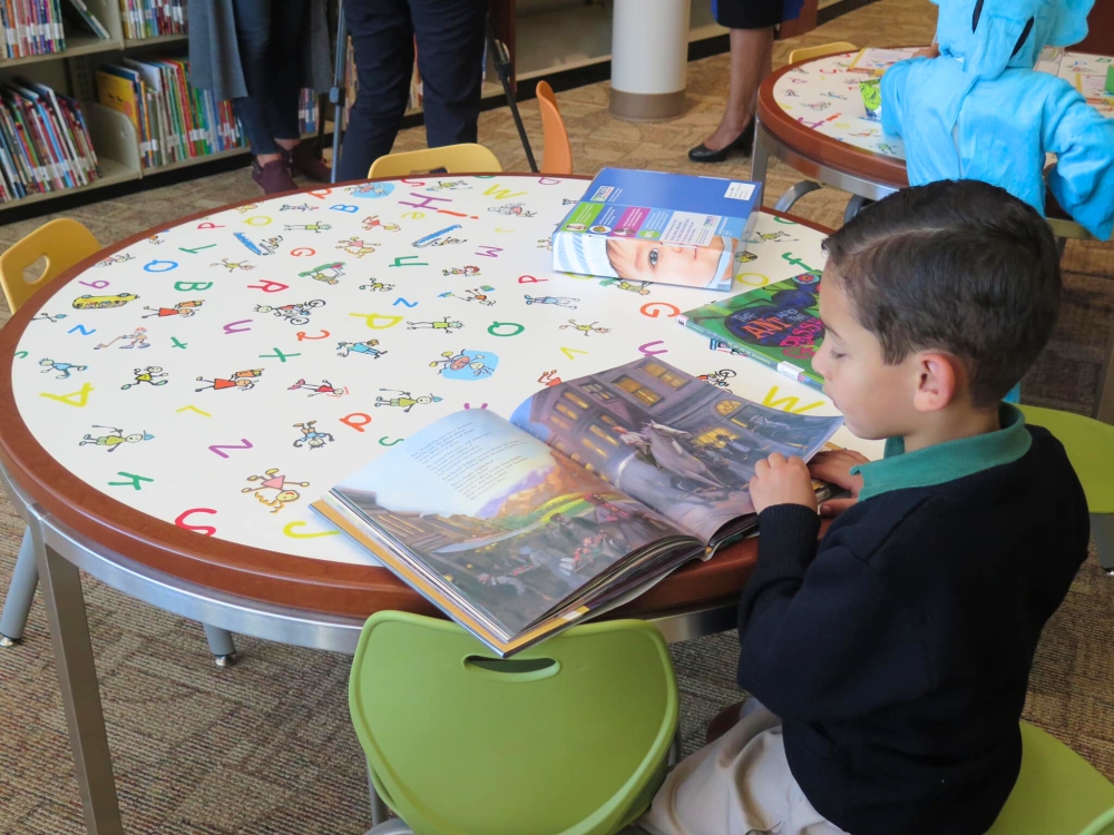 Child reading in a library.