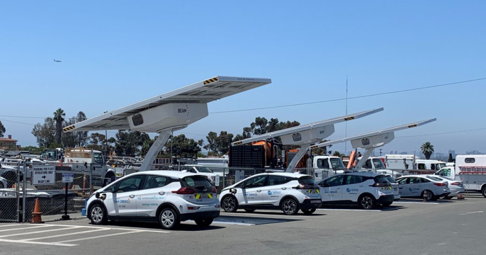 four green fleet cars in a parking lot