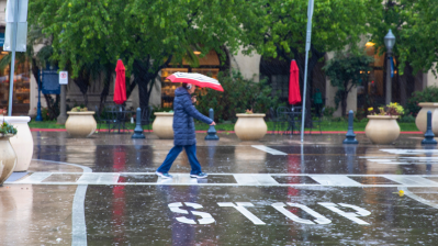 man with umbrella walking in the rain