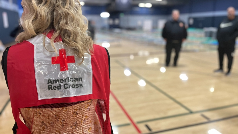 Red Cross worker standing in front of Muni Gym.