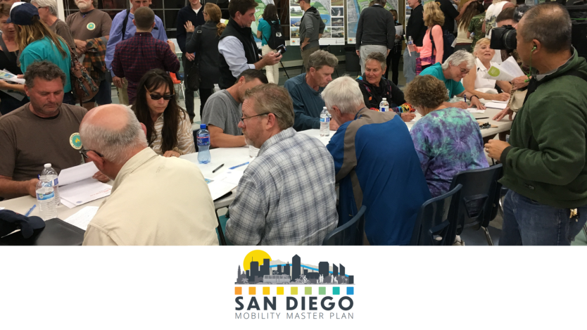 community members sitting at a table talking at a forum