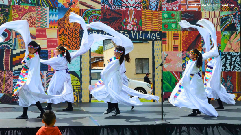 performers wearing white on stage 