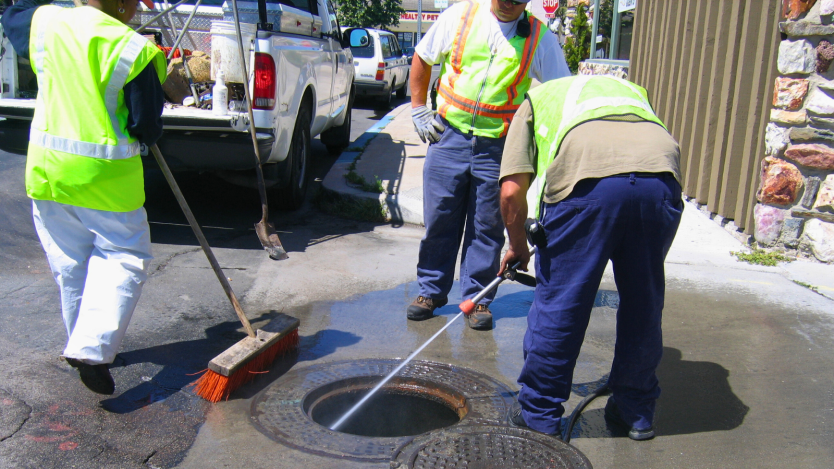 crews cleaning sewer line