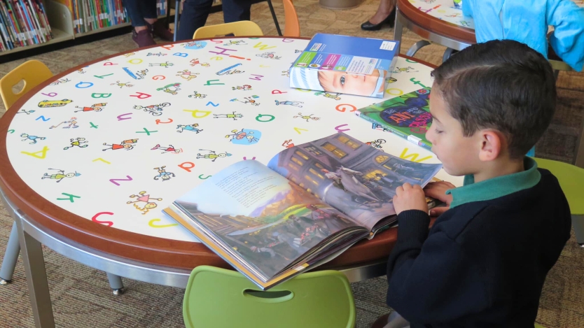 Child reading in a library.